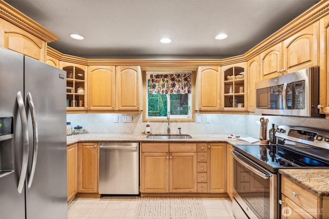 17922 Marine View Dr SW, Normandy Park, WA 98166 - kitchen featuring glass insert cabinets, a sink, stainless steel appliances, light stone countertops, and light tile patterned flooring