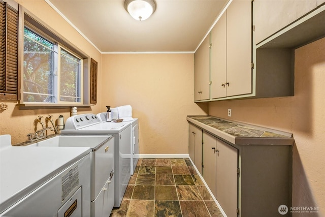 17922 Marine View Dr SW, Normandy Park, WA 98166 - laundry area featuring washing machine and dryer, cabinet space, stone finish floor, crown molding, and baseboards