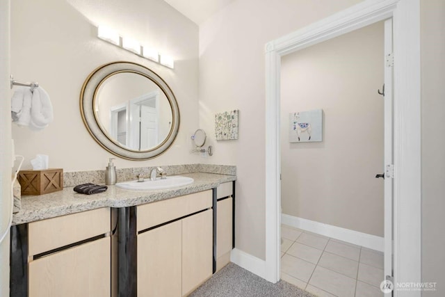 bathroom featuring tile patterned flooring, baseboards, and vanity