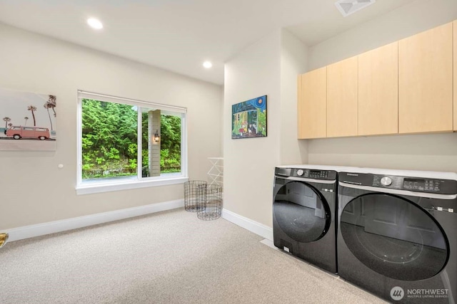 washroom with carpet, cabinet space, washing machine and clothes dryer, visible vents, and baseboards