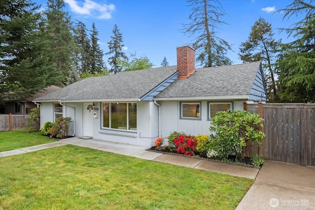 view of front of house with a shingled roof and a chimney