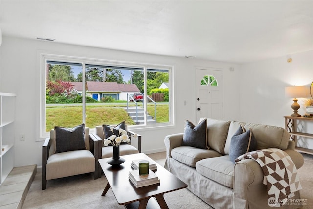 living room with plenty of natural light and carpet floors