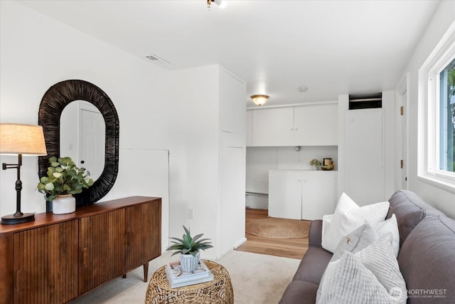 living area with light colored carpet