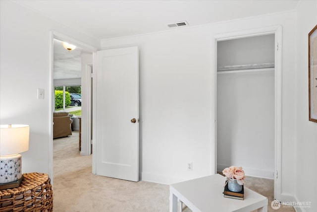 bedroom with light colored carpet and a closet
