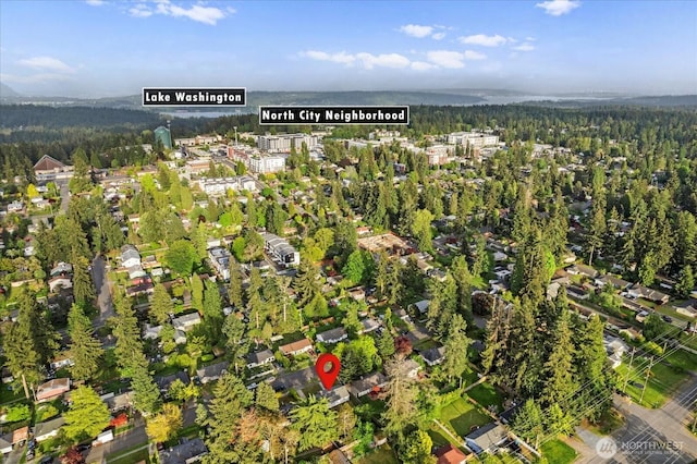 aerial view of property and surrounding area with a forest