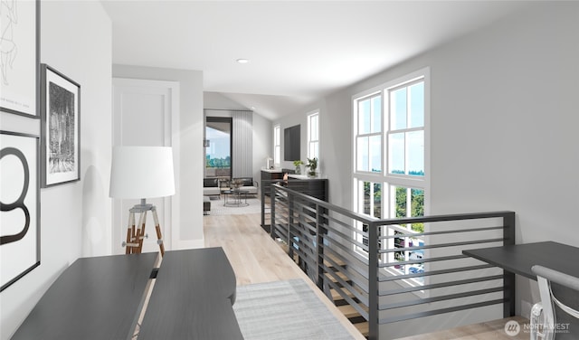 hall with light wood-style floors, an upstairs landing, and recessed lighting