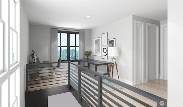 interior space with wood finished floors, baseboards, and recessed lighting