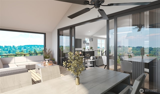 dining space with a fireplace, ceiling fan, and high vaulted ceiling