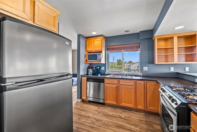 8075 Harborview Rd Unit 301, Blaine, WA 98230 - kitchen featuring stainless steel appliances, a sink, dark countertops, light wood-style flooring, and recessed lighting