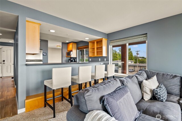 8075 Harborview Rd Unit 301, Blaine, WA 98230 - living area with wood finished floors, recessed lighting, bar, and baseboards