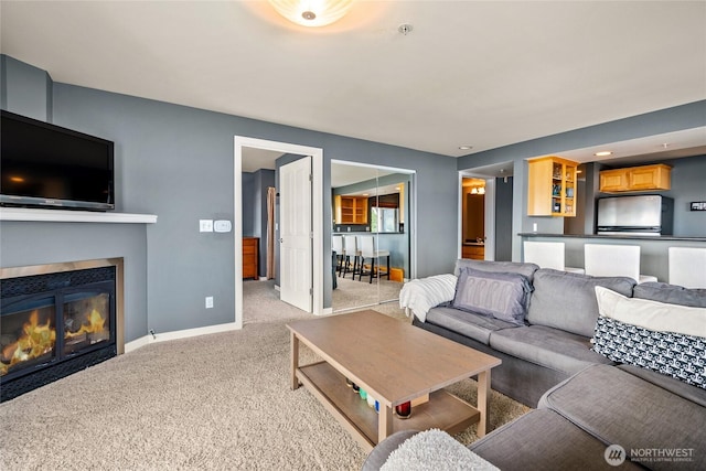 8075 Harborview Rd Unit 301, Blaine, WA 98230 - living room featuring carpet, a glass covered fireplace, and baseboards