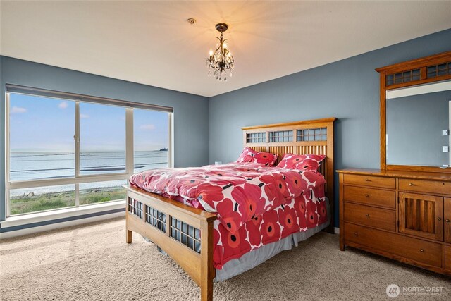 8075 Harborview Rd Unit 301, Blaine, WA 98230 - carpeted bedroom with a water view and a chandelier