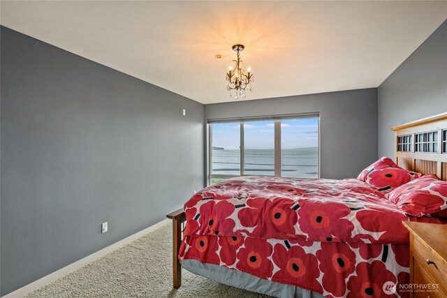 8075 Harborview Rd Unit 301, Blaine, WA 98230 - bedroom featuring carpet, a chandelier, a water view, and baseboards