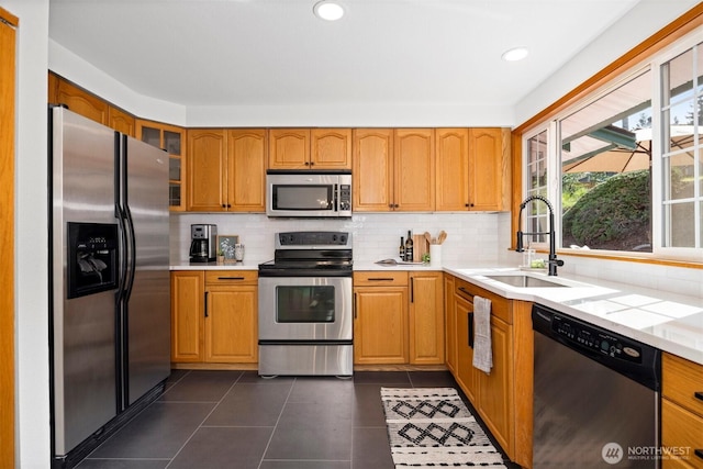 3785 Greenville Pl, Bellingham, WA 98226 - kitchen with appliances with stainless steel finishes, a sink, light countertops, decorative backsplash, and glass insert cabinets