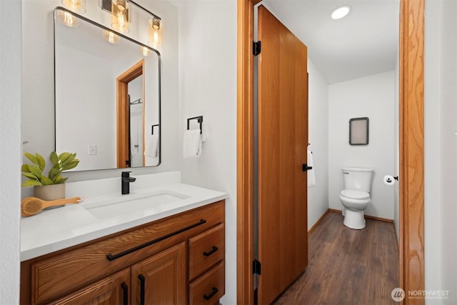 3785 Greenville Pl, Bellingham, WA 98226 - bathroom featuring wood finished floors, toilet, vanity, and baseboards