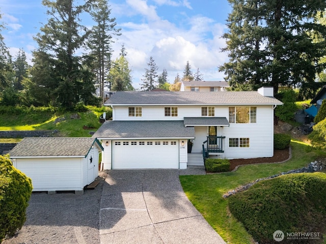 3785 Greenville Pl, Bellingham, WA 98226 - view of front of home featuring concrete driveway, an attached garage, a storage shed, a front lawn, and an outdoor structure