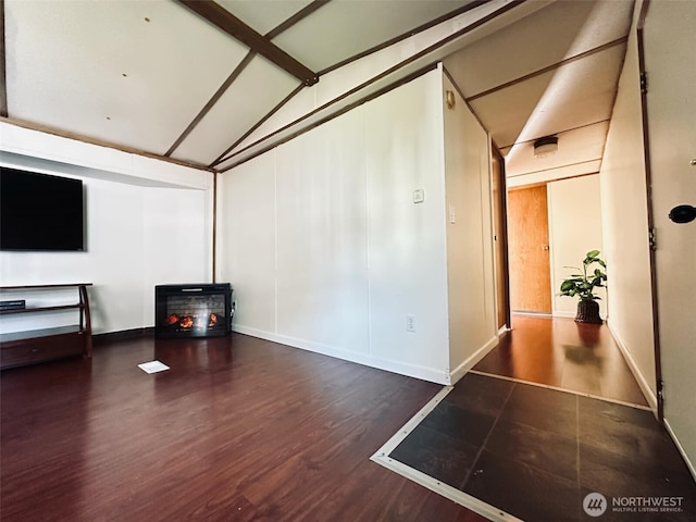 unfurnished living room featuring wood finished floors and baseboards