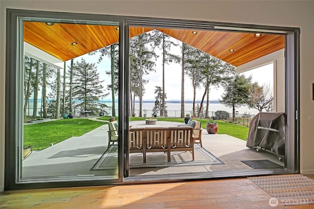 doorway featuring a water view, wood ceiling, recessed lighting, and hardwood / wood-style floors