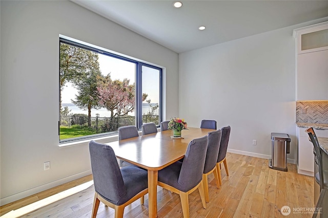 dining space featuring light wood-style floors, recessed lighting, and a wealth of natural light