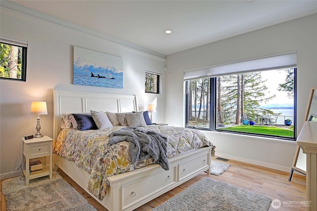 bedroom with baseboards, recessed lighting, wood finished floors, and visible vents