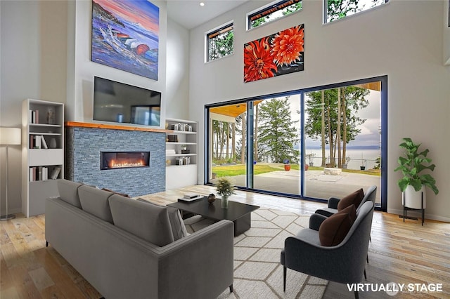 1699 SE Camano Dr, Camano Island, WA 98282 - living room featuring a towering ceiling, hardwood / wood-style flooring, and a fireplace