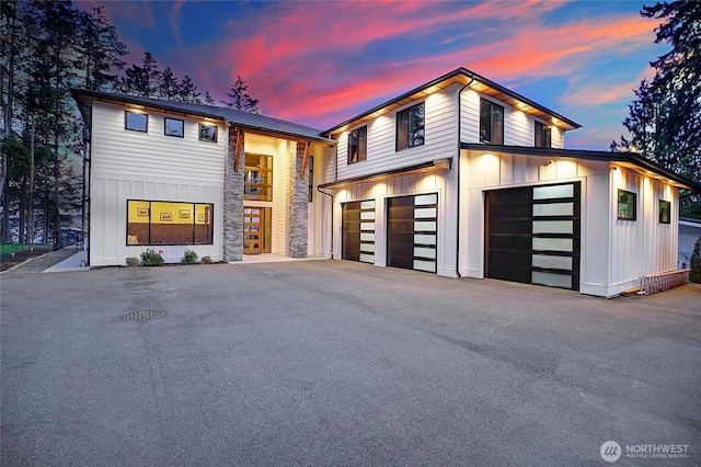 1699 SE Camano Dr, Camano Island, WA 98282 - contemporary house with board and batten siding, stone siding, driveway, and a garage