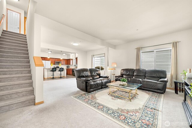 343 Tremont Ave Unit 102, Bellingham, WA 98226 - living area featuring stairway, light carpet, and baseboards