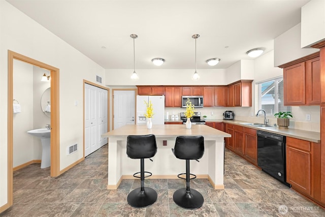 343 Tremont Ave Unit 102, Bellingham, WA 98226 - kitchen with a sink, stainless steel appliances, visible vents, light countertops, and a kitchen island