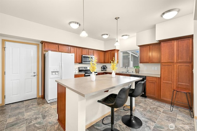 343 Tremont Ave Unit 102, Bellingham, WA 98226 - kitchen with light countertops, appliances with stainless steel finishes, stone finish floor, and a kitchen island