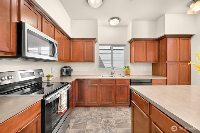 343 Tremont Ave Unit 102, Bellingham, WA 98226 - kitchen featuring light countertops, stainless steel appliances, and a sink
