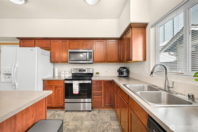 343 Tremont Ave Unit 102, Bellingham, WA 98226 - kitchen with a sink, stainless steel appliances, light countertops, and brown cabinets