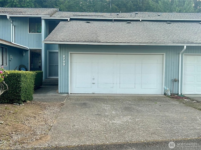 garage featuring concrete driveway
