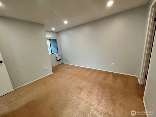 empty room with recessed lighting, carpet flooring, baseboards, and an AC wall unit