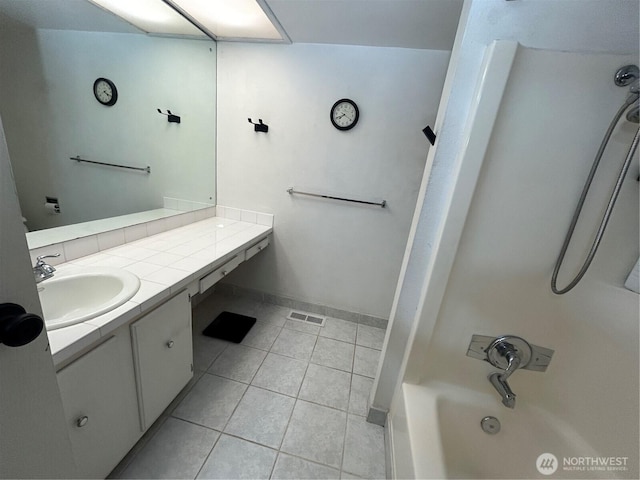full bath with vanity, bathtub / shower combination, tile patterned floors, and baseboards