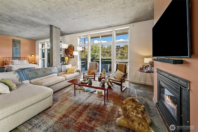 125 E Lynn St Unit 205, Seattle, WA 98102 - living area with a glass covered fireplace, concrete floors, and baseboards