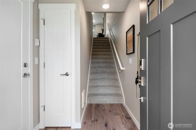 entryway featuring stairway, baseboards, and wood finished floors