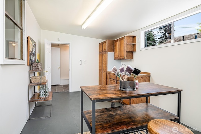 dining space featuring concrete floors