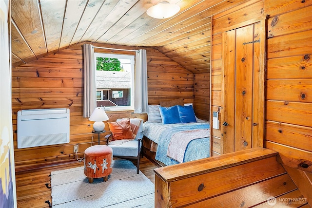 bedroom featuring vaulted ceiling, wood finished floors, wood walls, wood ceiling, and heating unit