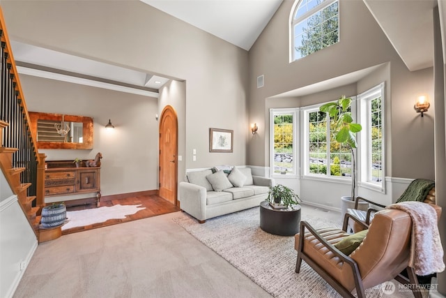 14028 104th Street Ct E, Puyallup, WA 98374 - carpeted living area featuring stairway, baseboards, and high vaulted ceiling