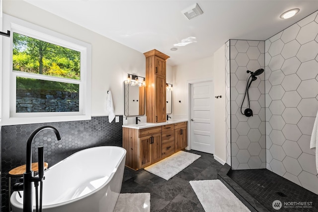 14028 104th Street Ct E, Puyallup, WA 98374 - bathroom featuring tile walls, double vanity, a soaking tub, and tiled shower
