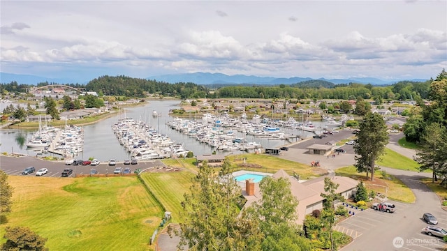 drone / aerial view of a marina and a water and mountain view
