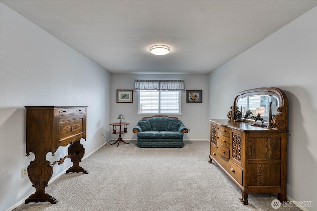 sitting room featuring carpet floors and baseboards