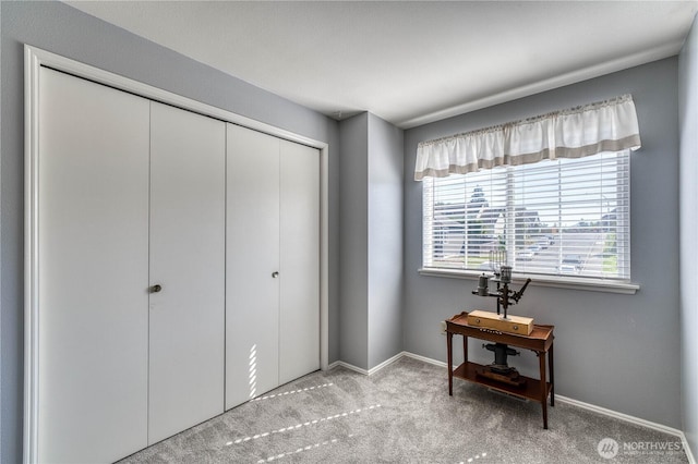bedroom with carpet, a closet, and baseboards