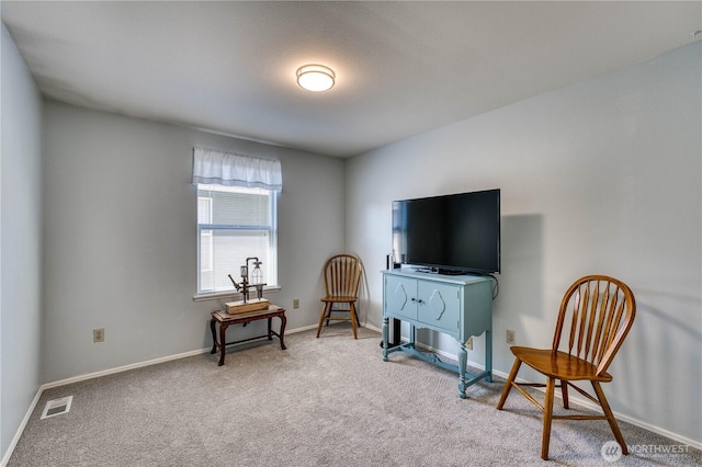 living area featuring carpet floors and baseboards