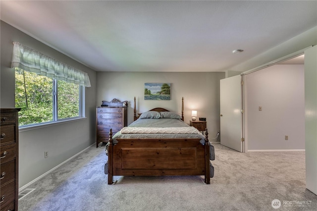 bedroom featuring light carpet and baseboards