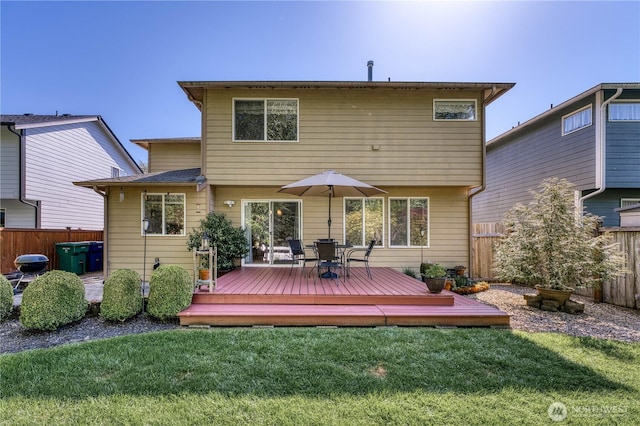 rear view of house with a deck and outdoor dining area