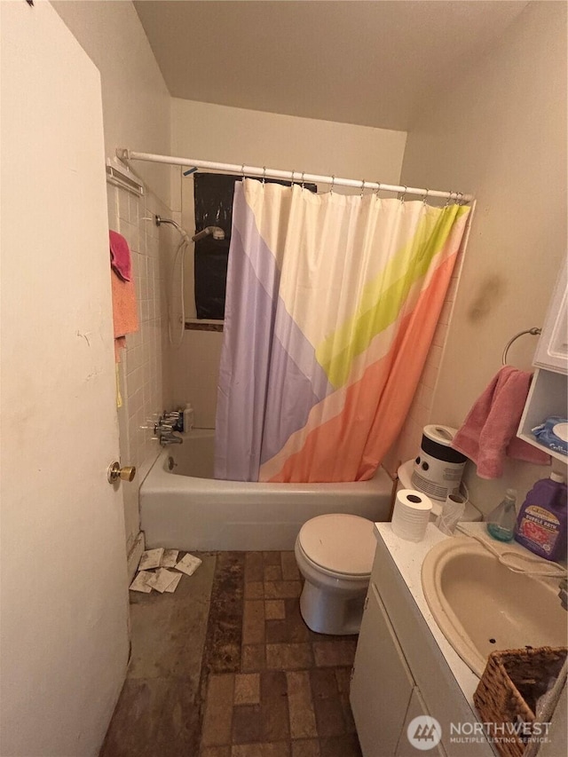 bathroom featuring vanity, shower / tub combo with curtain, and toilet