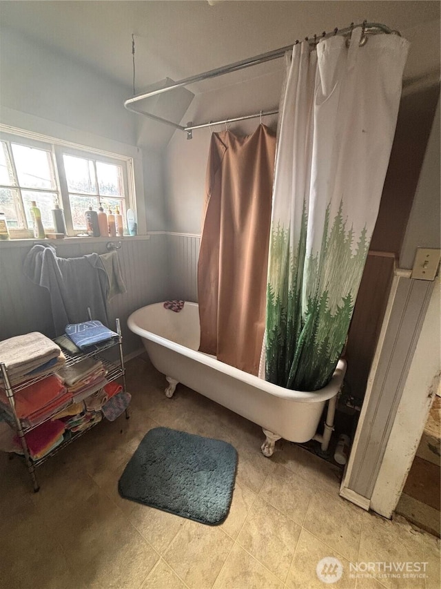 full bathroom with a wainscoted wall and tile patterned floors