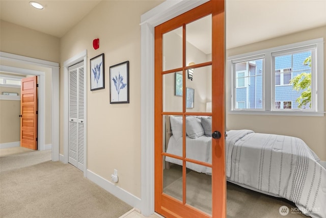 corridor with carpet floors, baseboards, and recessed lighting