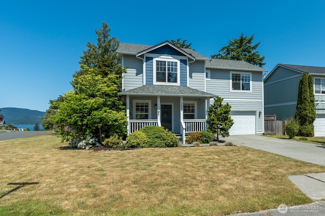 3828 Sutton Pl, Anacortes, WA 98221 - traditional home with driveway, a porch, a garage, a front lawn, and a shingled roof